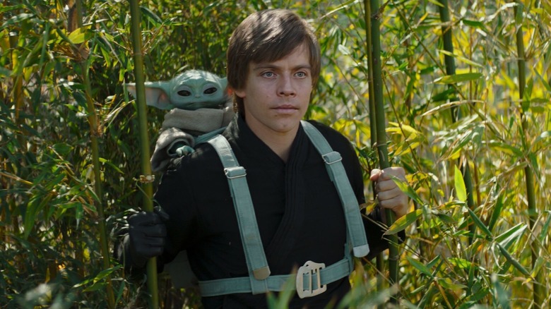 Deepfake Luke Skywalker staring vacantly ahead while Grogu sits on his back in The Book of Boba Fett (2021)