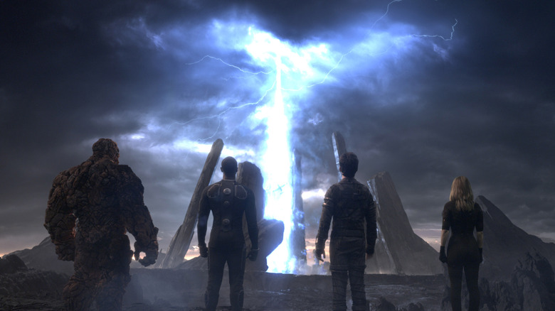 Johnny Storm, Reed Richards, the Thing, and Susan Storm looking up at threat in "Fantastic Four"
