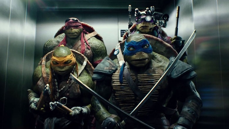 Rafael, Donatello, Leonardo, and Michelangelo standing in an elevator in "Teenage Mutant Ninja Turtles"