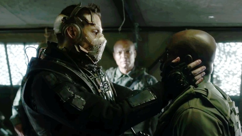 Bane holding a man by the face in "Gotham"