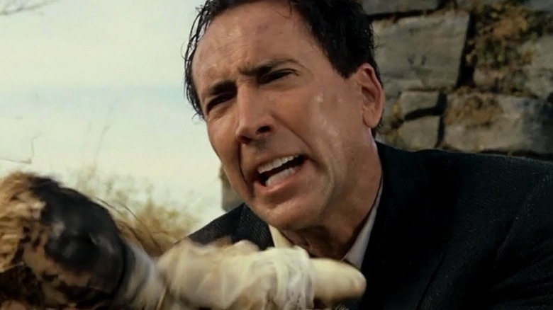 Edward Malus holds a burned doll in "The Wicker Man" (2006)
