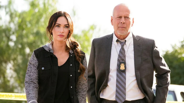 Megan Fox and Bruce Willis look off to side