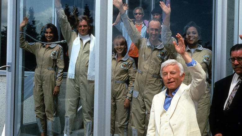 Bud and Doyle wave hello from inside a biosphere in 'Bio-Dome' (1996)
