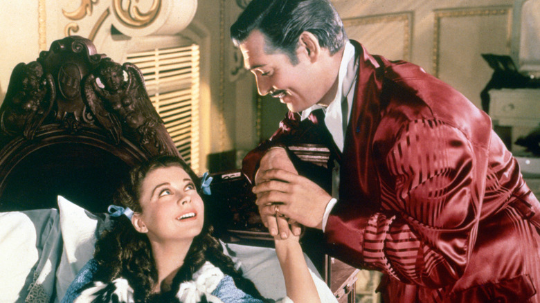 Scarlett being embraced by Rhett in Gone with the Wind (1939)