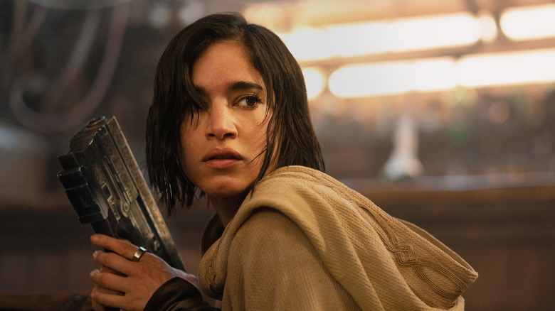 Kora brandishes a gun in "Rebel Moon"