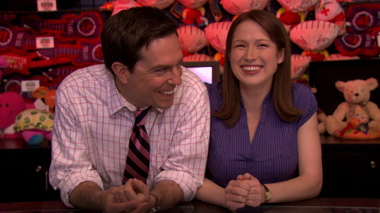 Andy and Erin laughing and leaning together on a counter at an arcade on "The Office" (2005-2013)