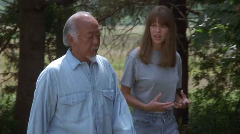 Pat Morita and Hilary Swank talking
