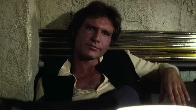 Han listening to Greedo talk in Star Wars: Episode IV — A New Hope (1977)