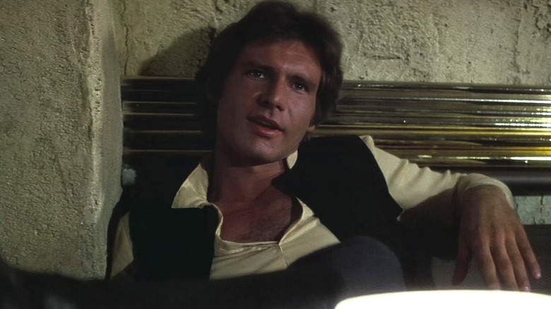 Han listening to Greedo talk in Star Wars: Episode IV — A New Hope (1977)