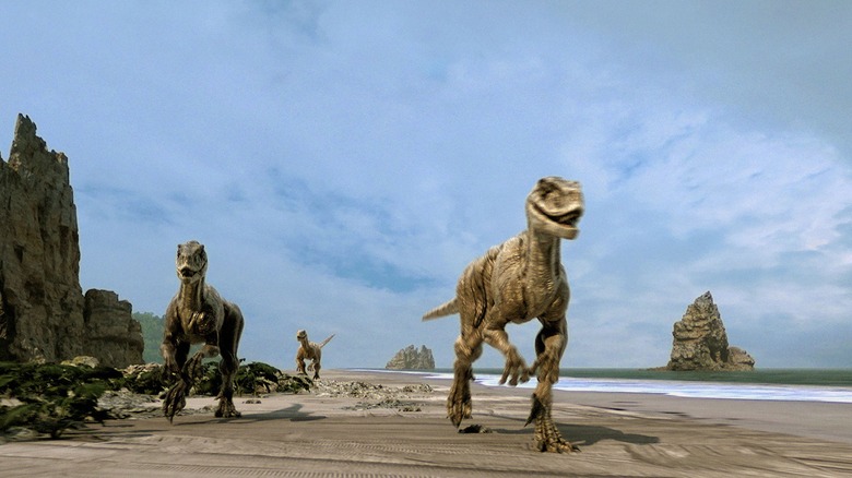 A bunch of raptors roaming on the beach in The Land That Time Forgot (2009)