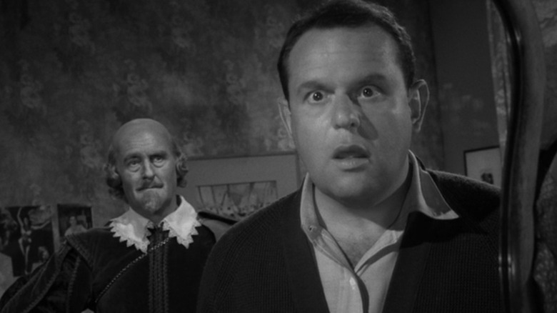 William Shakespeare (played by John Williams) alongside the screenwriter Julius Moomer (played by Jack Weston) looking into a mirror on 