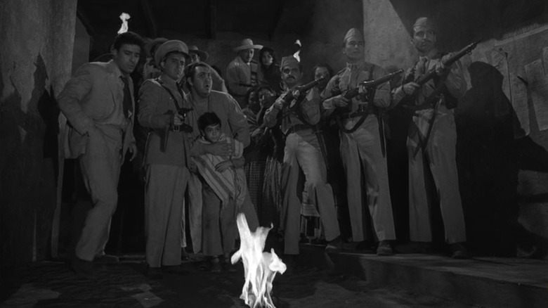 Townspeople and members of the Mexican Army look on in horror at the end of "The Gift" in "The Twilight Zone."
