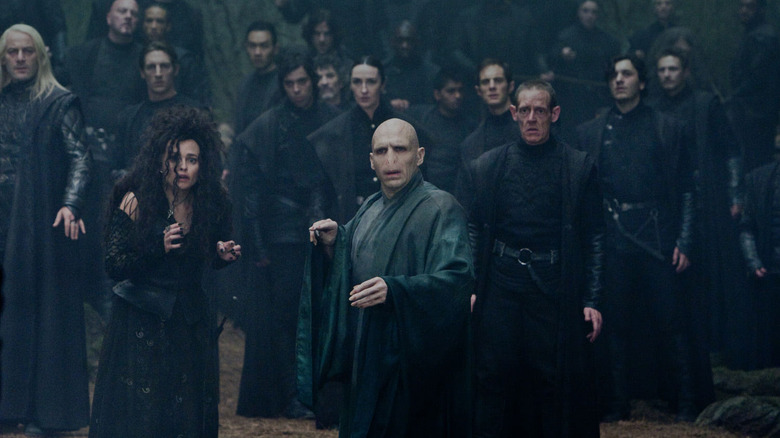 Voldemort surrounded by Death Eaters including Malfoy and Bellatrix Lestrange in Harry Potter and the Deathly Hallows Part 2