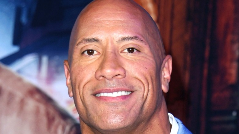 Dwayne Johnson poses at event 