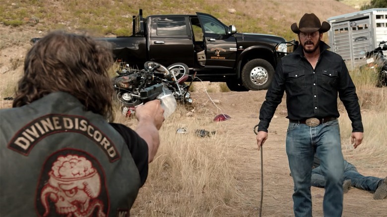 Biker pointing a gun at Rip