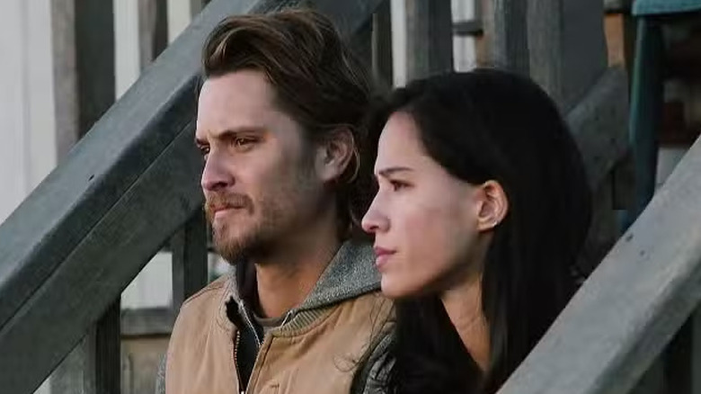 Kayce and Monica sit on the stairs together in "Yellowstone" (2018-2024)
