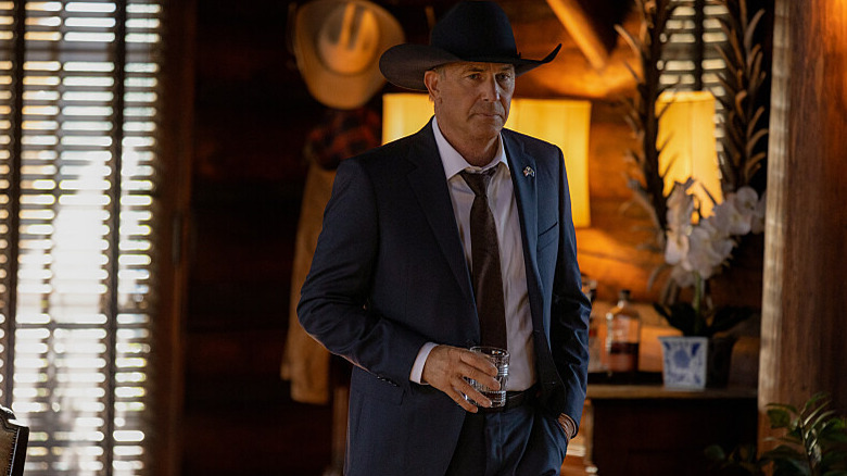 John Dutton holding a whiskey
