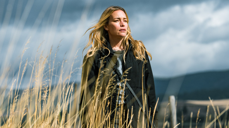 Summer Higgins standing in tall grass in "Yellowstone"