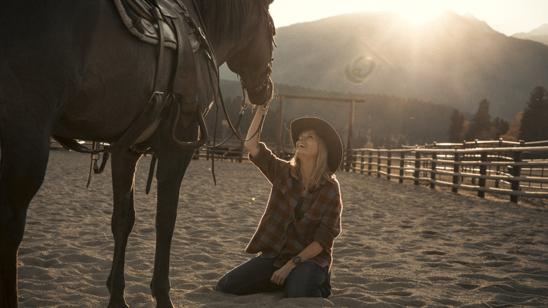 Beth smiling at a horse