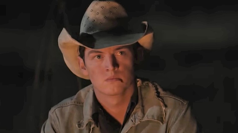 Teenage Rip frowning under a beat up hat in "Yellowstone."