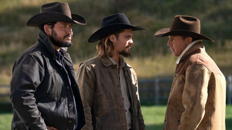 Kayce, Rip and John in profile and wearing cowboys hats in "Yellowstone"