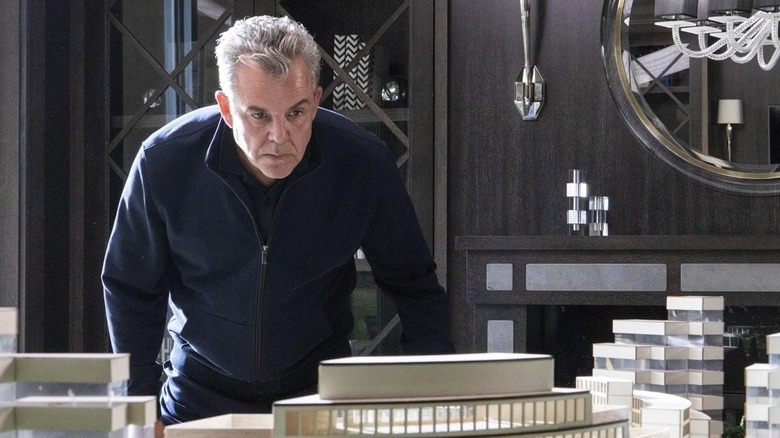 Danny Huston looking at model city