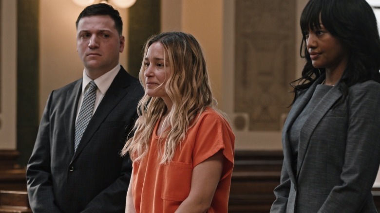 Piper Perabo standing between lawyers on Yellowstone