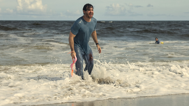 Mike Valentine standing in the water at a beach 