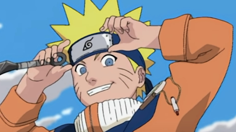 Naruto smiling and adjusting his headband