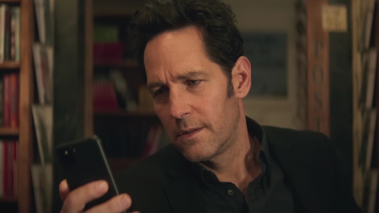 Paul Rudd as Scott lang reading on phone