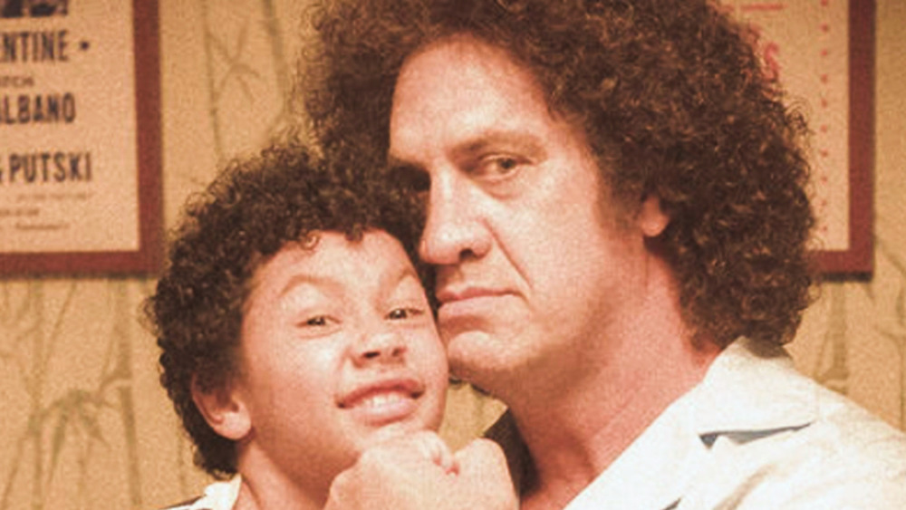 Matthew Willig as Andre the Giant hugging little Dwayne Johnson