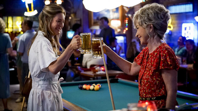 Mary and Connie toasting mugs of beer next to a pool table at a bar in "Young Sheldon"