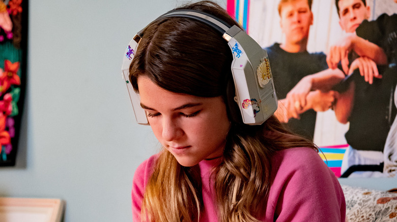Missy listening to music and writing in her journal