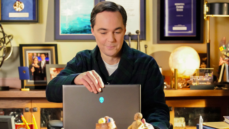 Sheldon smiling at laptop