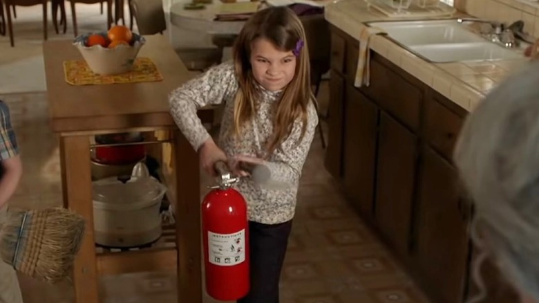 Missy holding fire extinguisher