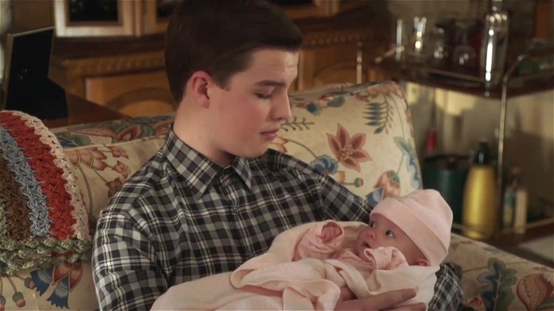 Young Sheldon holding baby Constance
