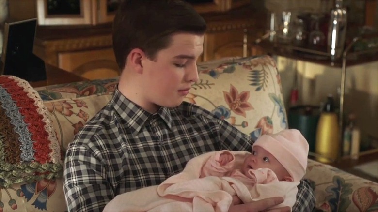 Young Sheldon holding baby Constance