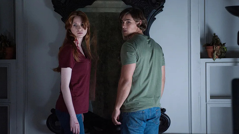 Kaylie and Tim standing in front of a mirror in Oculus