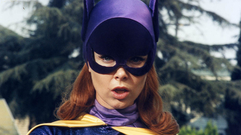 Batgirl with trees behind her
