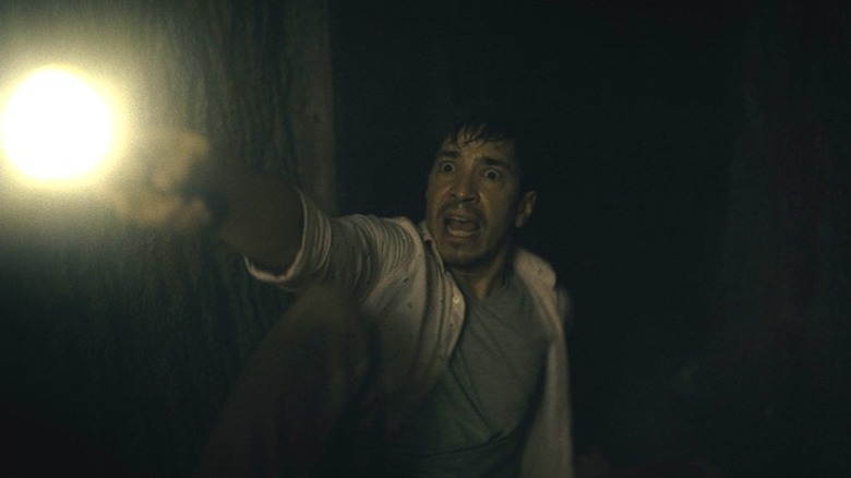 AJ holding flashlight looking terrified