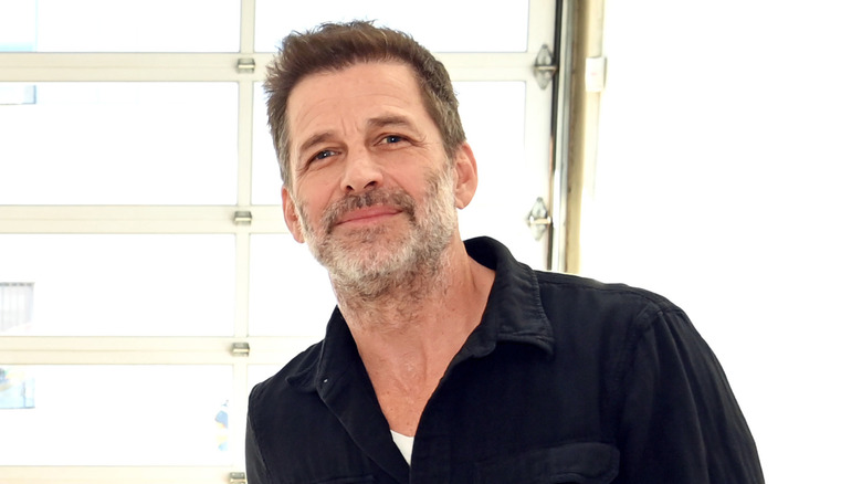 Zack Snyder leaning over and smiling