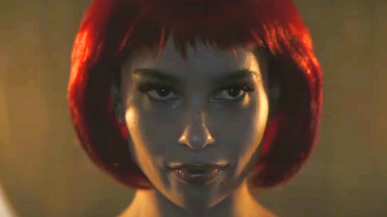Selina Kyle looking intensely in red wig