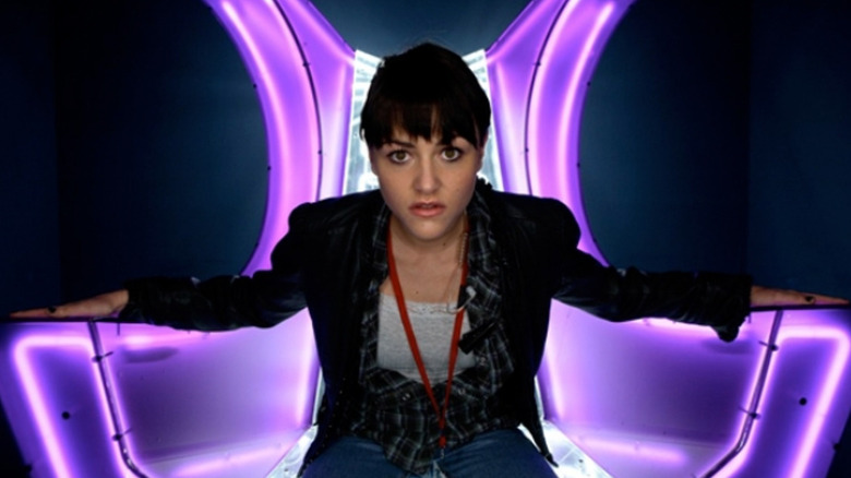 Kelly Povell sitting in purple chair on Dead Set